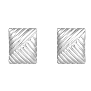 Macro view of silver square stud earrings featuring a refined diagonal grooved texture