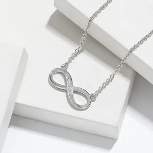 Macro view of sterling silver infinity pendant necklace with sparkling zircon details