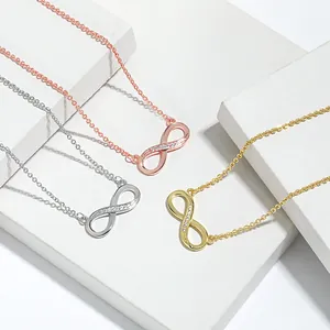 Detailed view of infinity symbol necklaces in rose gold, silver, and gold metal finishes