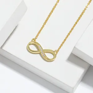 Detailed view of a gold infinity necklace with shimmering cubic zirconia stones.