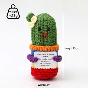 Detailed view of handmade crochet cucumber doll holding an emotional support card