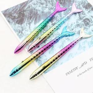 Detail view of colorful gradient mermaid tail novelty pens with fish scale texture.