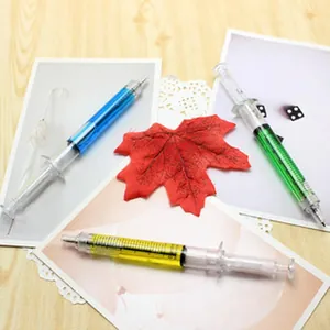 Detail view of creative syringe-shaped pens with colorful liquid designs.