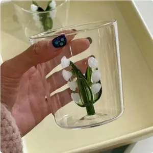 Detailed view of the handcrafted 3D lily of the valley flower inside a clear glass cup