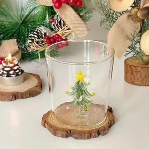 Detailed close-up of a clear glass cup with a festive internal 3D Christmas tree design