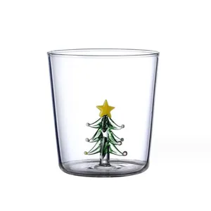 Transparent glass drinking cup featuring a 3D miniature green Christmas tree inside