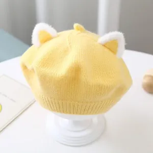 Adorable yellow children's knitted beret featuring soft plush cat ears detail.