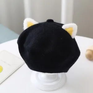 Detailed close-up view of the black knitted baby beret featuring cute plush cat ears design