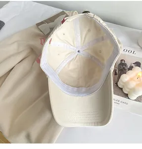 Interior detail view of cream-colored soft top baseball cap with deep crown structure