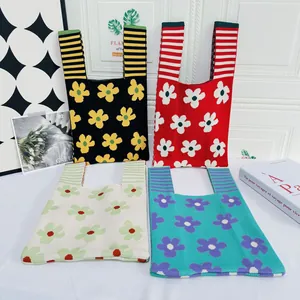 Detailed collection showing four colorful knitted tote bags with floral patterns on a table
