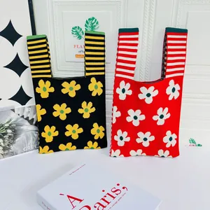 Details of floral knitted tote bags with contrasting stripes and flower patterns