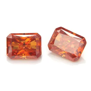 Macro view of two radiant cut vibrant orange moissanite gemstones on a white background