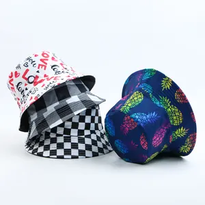 Detailed view of reversible bucket hats with heart, checkered, and pineapple prints