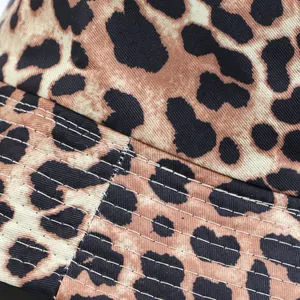 Close-up detail of leopard print bucket hat showing fabric texture and stitching