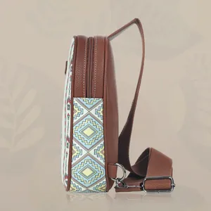 Detailed side view of ethnic style canvas chest bag with colorful geometric patterns