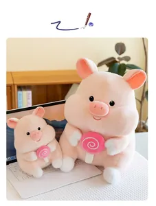 Close-up detail of cute pink plush pig toys holding lollipops in a cozy home setting