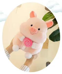 Close-up of a soft pink pig plush toy holding a cute pink swirl lollipop