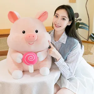 Large cute pink plush pig toy holding a pink lollipop for kids' birthday gift