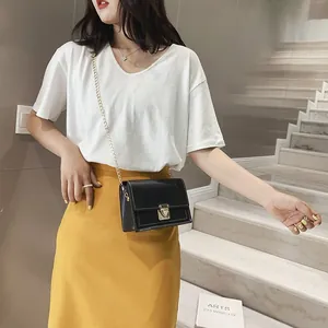 Trendy black crossbody bag with gold chain strap and metal lock detail for women.