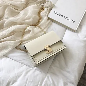 Chic cream-colored small square crossbody bag featuring gold chain strap and plug-lock closure