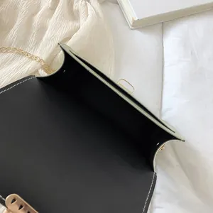 Detailed macro view showing the spacious black interior of a green chain crossbody bag