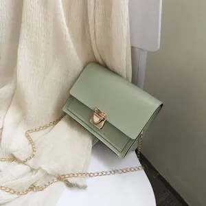 Sage green rectangular crossbody bag with gold-tone chain strap and push-lock detail