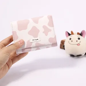 Pink and white cow print trifold mini wallet for women with milk label