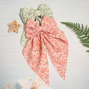 Close-up detail of Korean style floral fabric hair bow clips with elegant long streamers
