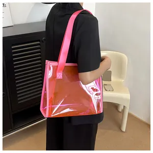 Macro view of large pink transparent gradient PVC jelly tote bag worn on shoulder