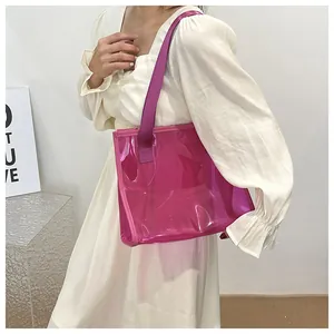 Stylish large capacity transparent pink jelly tote bag carried by model in white dress