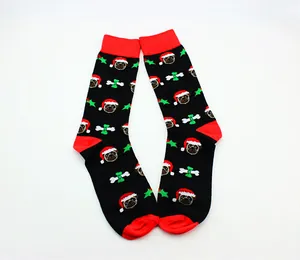 Close-up of Christmas crew socks featuring festive pug patterns with Santa hats and bones.