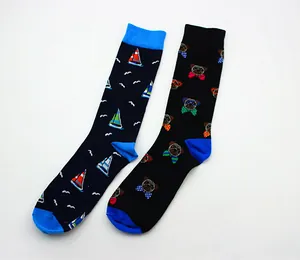 Detailed view of two crew socks featuring sailboat and cartoon pug patterns with blue accents.