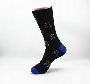 Detail view of black mid-calf socks with colorful pug pattern and blue accents