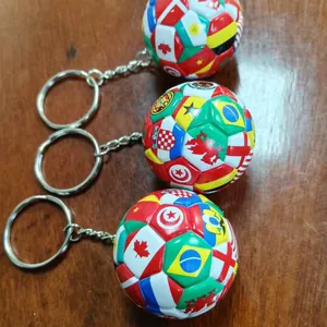 Set of three creative soccer ball keychains featuring colorful national flags for sports fans
