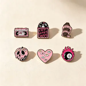 Set of 6 pink and black punk style enamel pins with gothic designs like skull and coffin