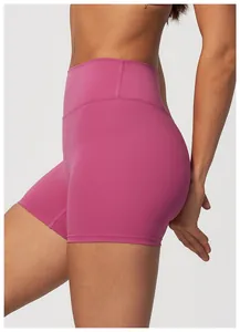 Close-up detail of pink high-waisted yoga shorts showcasing the seamless fit and material.