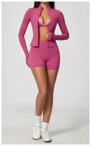 Full body shot of women's magenta yoga sports set with high waist shorts and jacket.