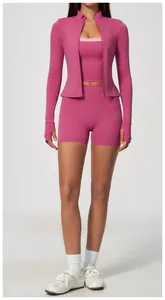 Close-up of pink three-piece yoga set featuring high-waisted shorts and zip-up jacket