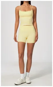 Front view of pale yellow high-waisted yoga shorts and tank top set on a model