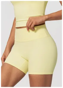 Macro view of high-waisted pale yellow yoga shorts showing seamless nude feel fabric