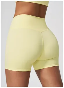 Detailed view of yellow high-waisted yoga shorts with quick-dry nude feel fabric