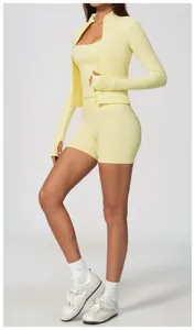 Fitness model wearing pale yellow high-waisted yoga shorts and a matching sports jacket