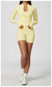 Close-up of pale yellow yoga set with high-waisted shorts and a slim-fit zip-up sports jacket