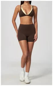 Full body studio shot of woman wearing chocolate brown high-waisted yoga shorts and bra