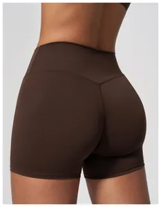 Detailed back view of high-waisted brown yoga shorts featuring a V-shaped seam detail