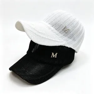 Close-up detail showing the breathable mesh texture and metal M logo on knitted caps