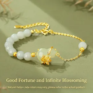 Close-up of elegant pale green jade bracelet with gold lotus and hulu pendants