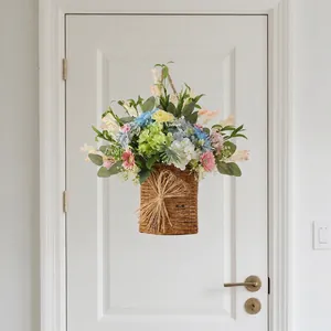 Vibrant artificial flower basket hanging on a white front door for spring decor