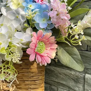 Detail of spring artificial floral door basket with pink gerberas and blue hydrangeas