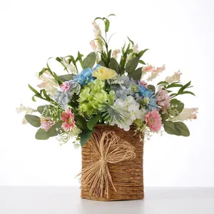 Vibrant spring artificial flower arrangement in a rustic woven hanging door basket decoration